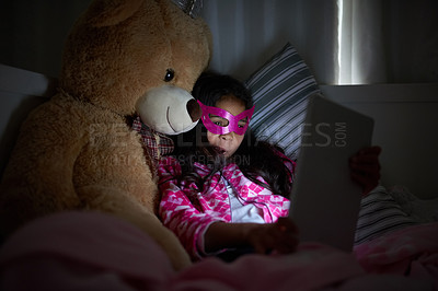 Buy stock photo Night, tablet and girl in bed with teddy bear for evening cartoon, games and mask for watching superhero movie. Dark, screen light and child in bedroom with tech for online reading and toy animal