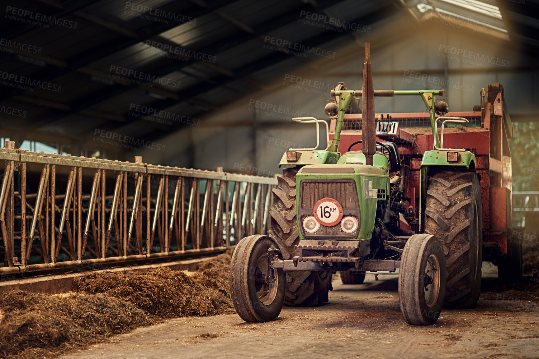 Buy stock photo Shot of a rusty old tractor standing in an empty barn