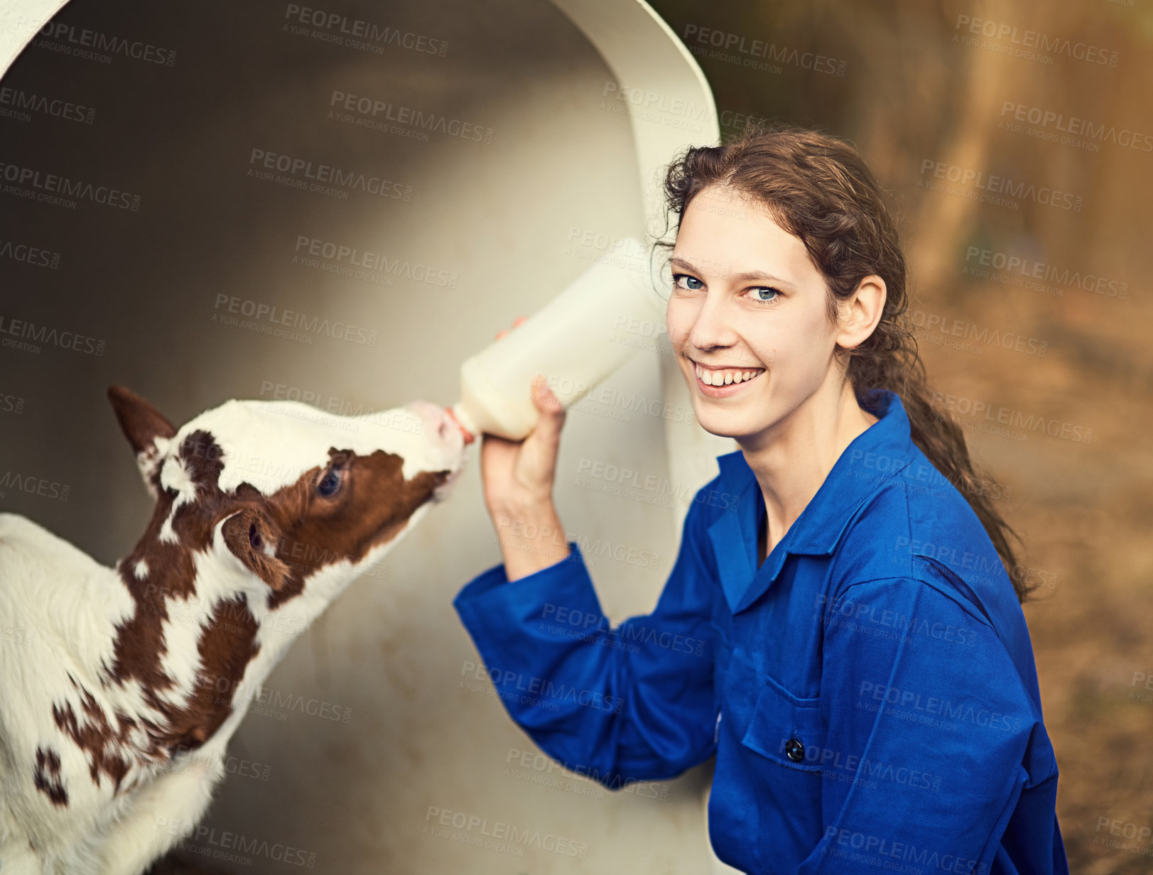 Buy stock photo Portrait, woman and milk in bottle for calf, feeding and smile for baby, drink and food of animal. Outdoor, healthy and female farmer with nutrition for cattle, happy and person in barn and livestock