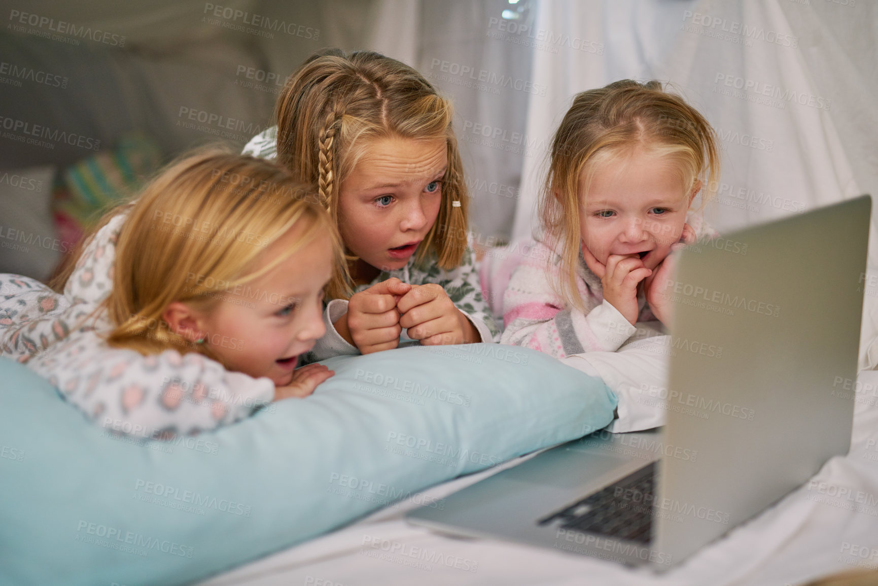 Buy stock photo Happy, girls and laptop for streaming tv or watching movies  before bedtime for relax and comfort. Exited, sisters or friends and computer for bonding with entertainment and film in blanket fort