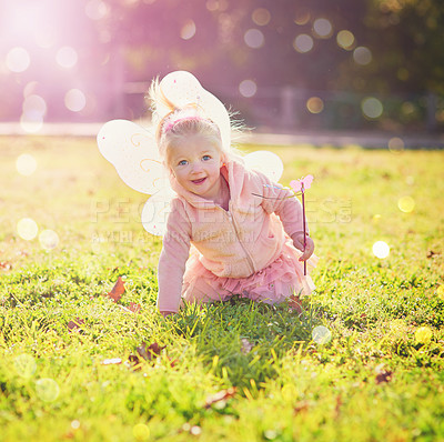 Buy stock photo Costume, girl and kid on grass, fairy and happiness with sunshine, cheerful and playful in park. Halloween, child and infant with wings, lens flare and joy with fun, spring and countryside with smile