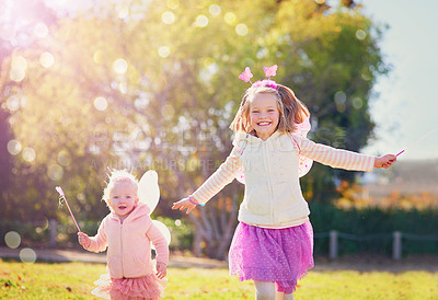 Buy stock photo Fairy, girl and siblings running in outdoor park with wings for dress up, princess outfit or cosplay. Bokeh, nature and young kids with happiness for fantasy play, childhood or halloween costume