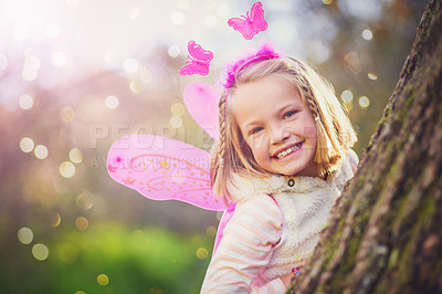 Buy stock photo Portrait of an adorable little girl dressed up as a fairy and having fun outside