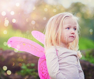 Buy stock photo Cropped shot of an adorable little girl dressed up as a fairy and having fun outside