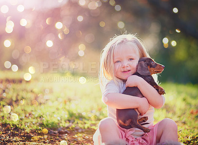 Buy stock photo Portrait, outdoor and hug of puppy by toddler, adorable and cute in park, love and care for animal. Nature, little girl and child with pet, relax and embrace of dog, grass and together on ground