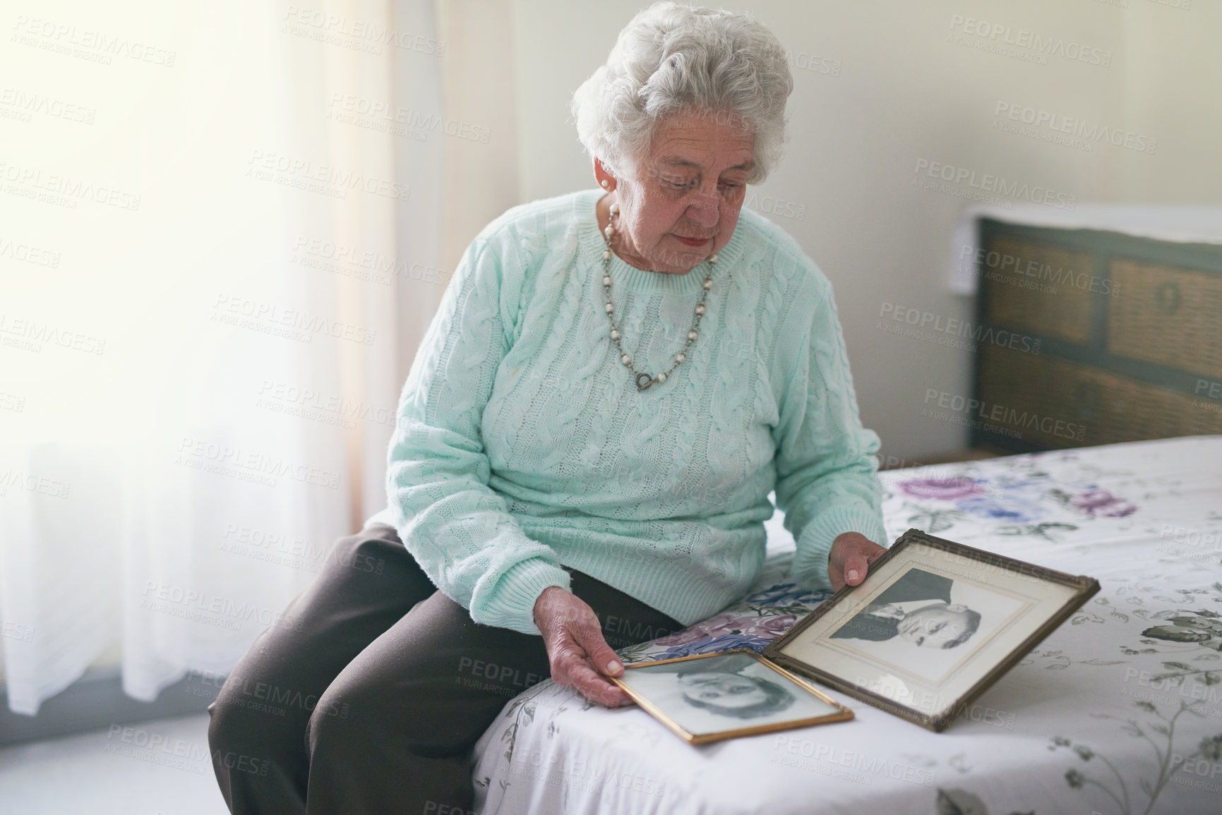 Buy stock photo Memory, frame and elderly woman on bed with picture for melancholy, family history and nostalgia. Senior person, lonely and retirement with photo at home for grief, remember and reminisce of husband