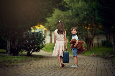 Buy stock photo Shot of a little girl and her brother walking away while carrying suitcases and toys