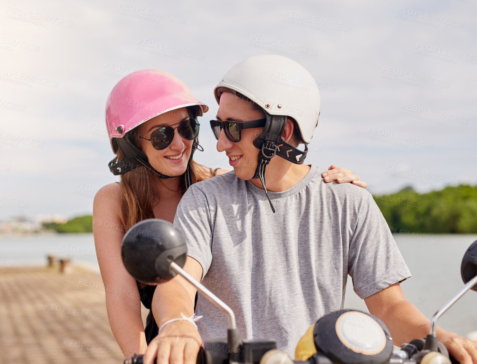 Buy stock photo Shot of a young couple out for a ride on a scooter