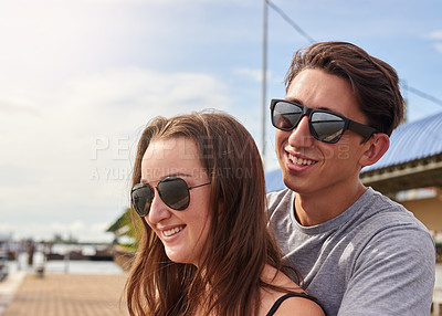 Buy stock photo Shot of an affectionate young couple standing together outside