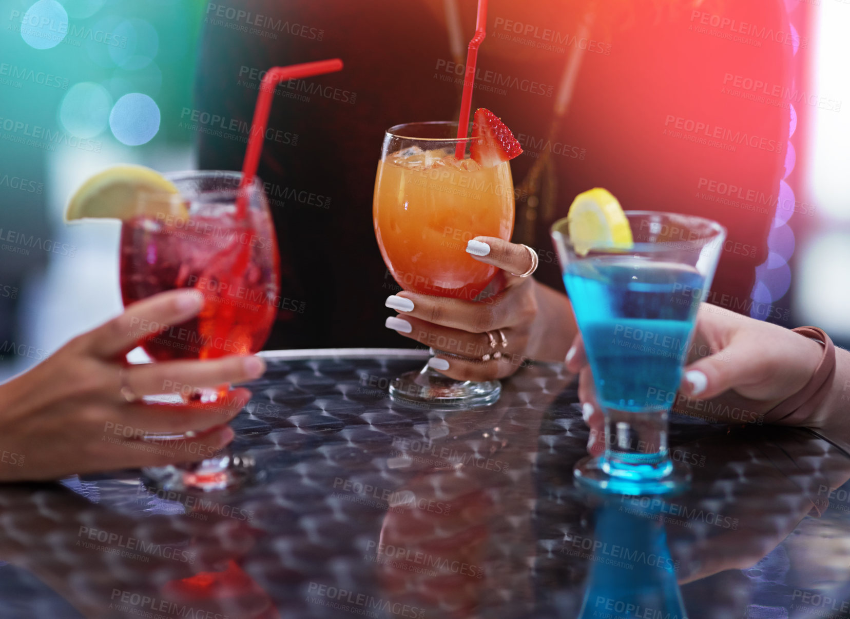Buy stock photo Cropped shot of a group of unidentifiable friends enjoying cocktails in a nightclub