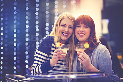 Buy stock photo Portrait of two friends enjoying cocktails in a nightclub