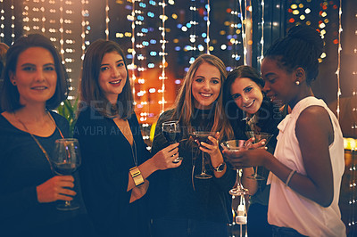 Buy stock photo Portrait of a group of happy friends enjoying drinks in a nightclub