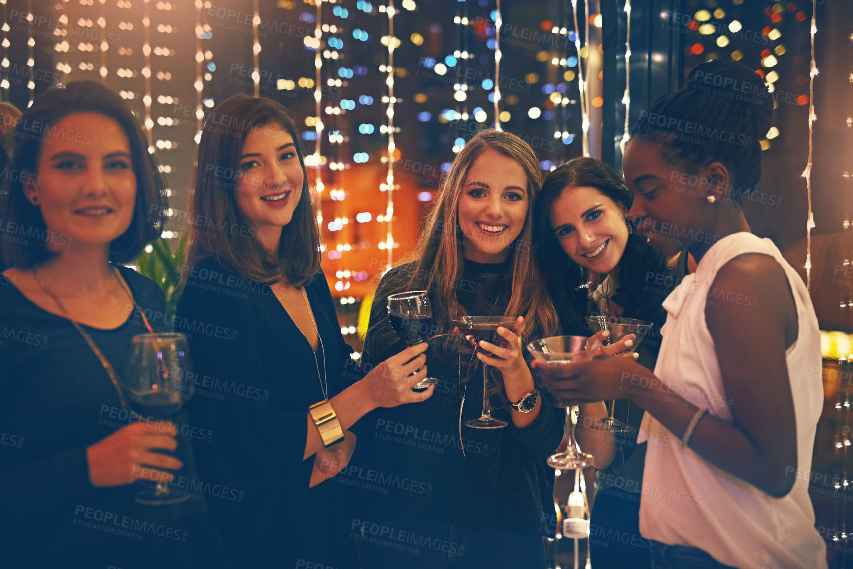 Buy stock photo Portrait of a group of happy friends enjoying drinks in a nightclub