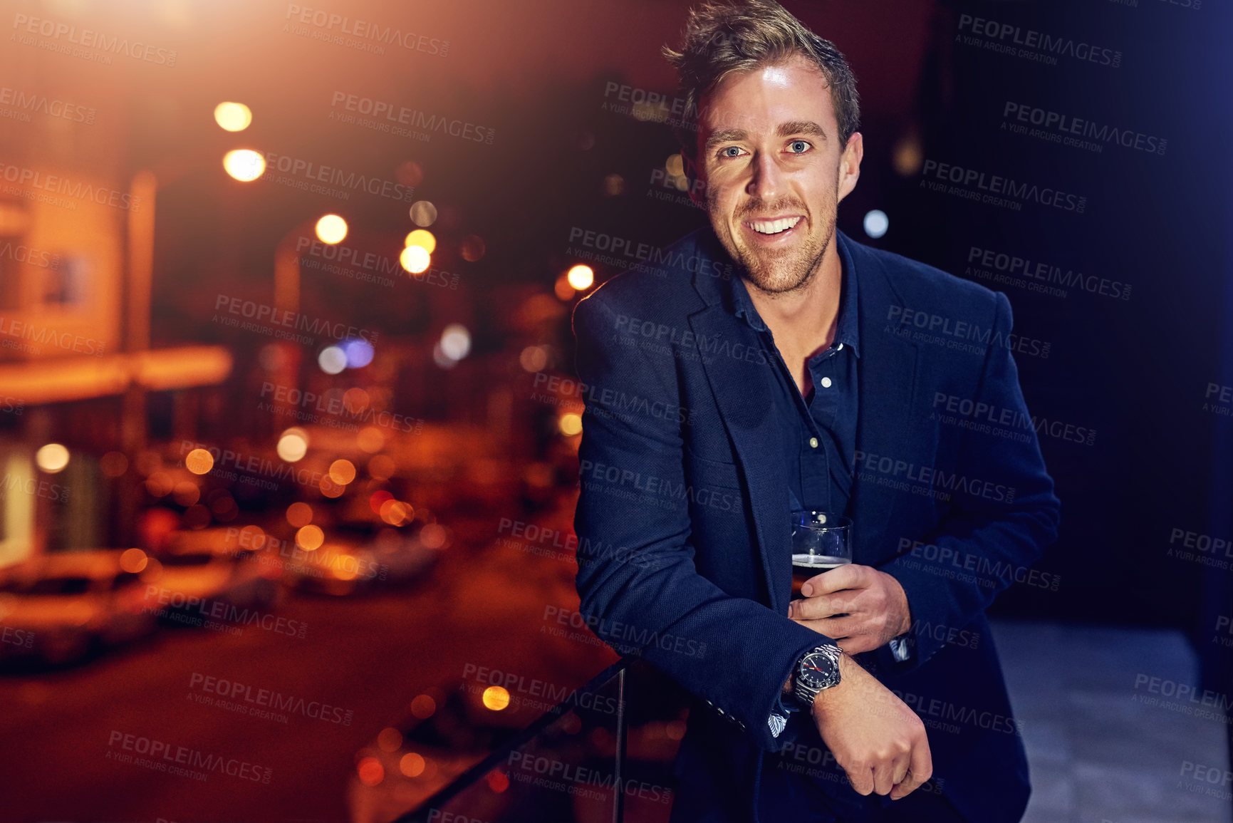 Buy stock photo Man, portrait and beer on balcony with smile at night, celebrate in city for wellness. Male person, alcohol or drink in outdoor for happy hour with glass, cheerful and dark in Chicago with beverage