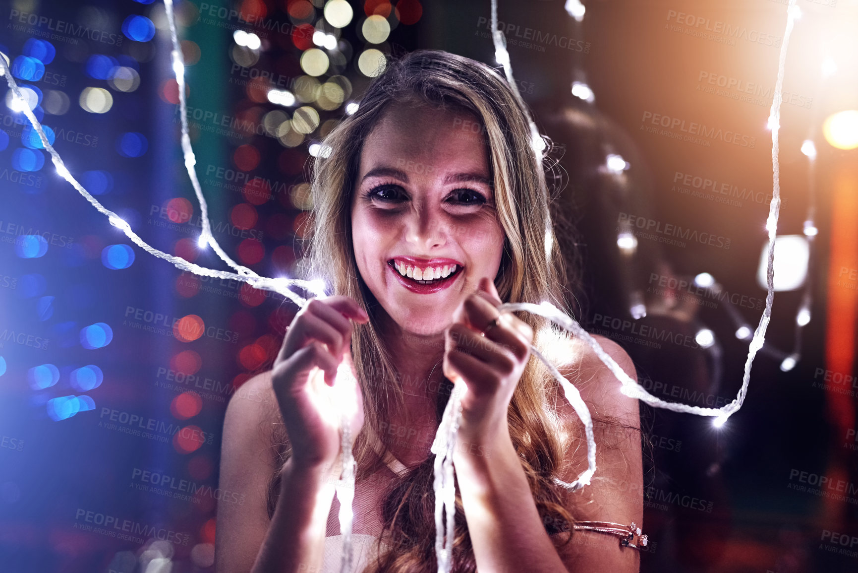 Buy stock photo Young woman, hands and string lights with smile for disco party or new years celebration at nightclub. Happy, female person and face at music event or rock festival with lens flare for weekend fun
