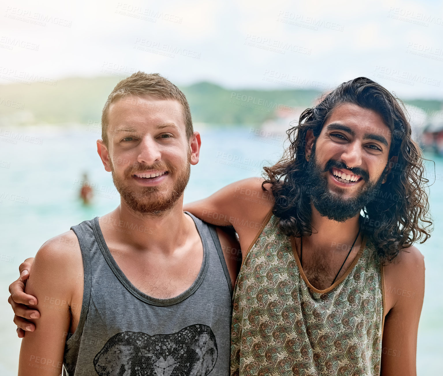 Buy stock photo Portrait of two male friends enjoying a day at the beach while on vacation