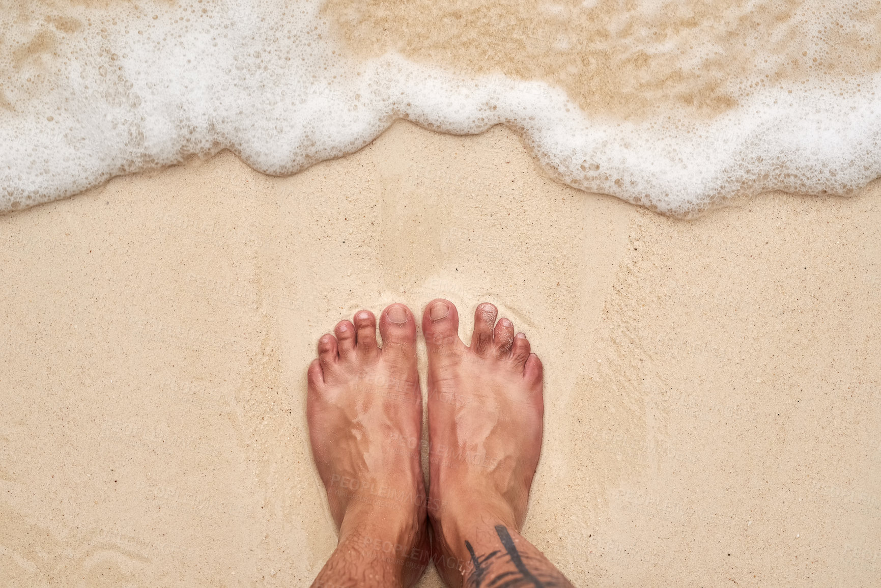 Buy stock photo High angle shot of a man's feet at the beach