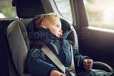Buy stock photo Cropped shot of an adorable little boy sitting in a car seat