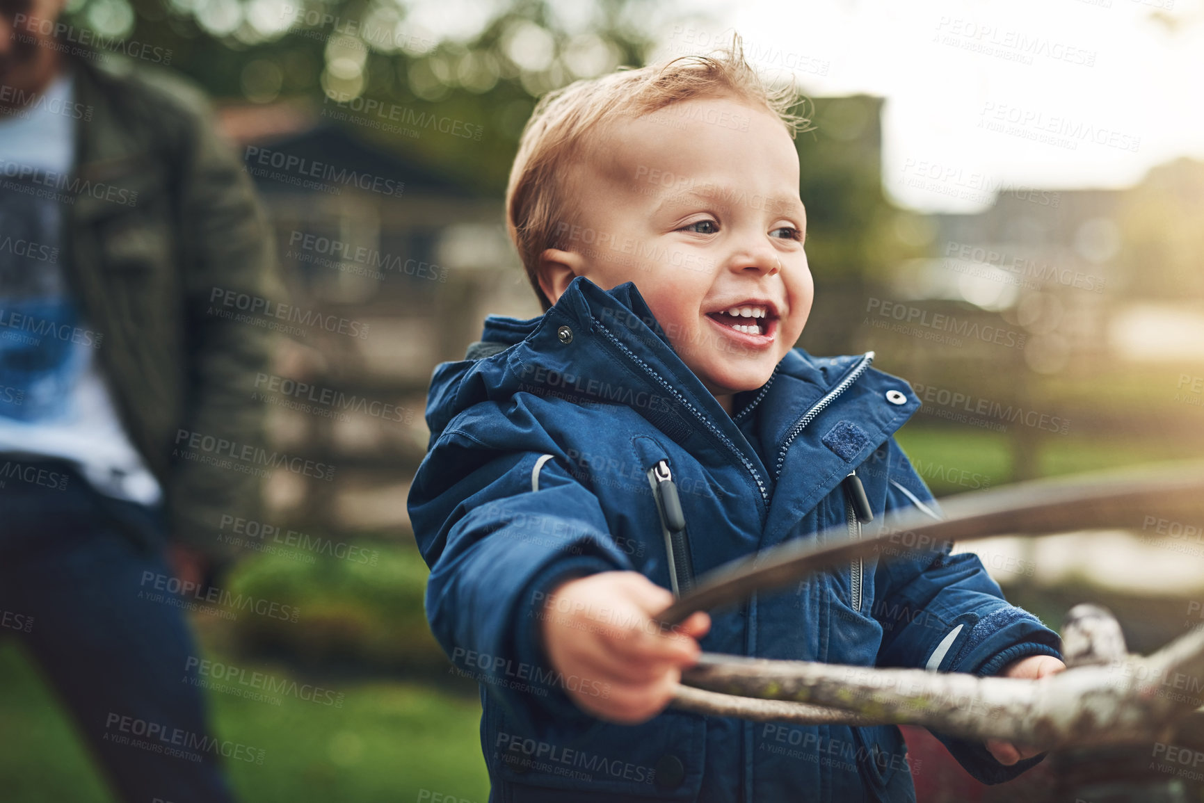 Buy stock photo Cropped shot of an adorable little boy playing on a farm tractor outside