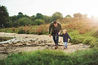 Buy stock photo Shot of a father out for a walk with his little son