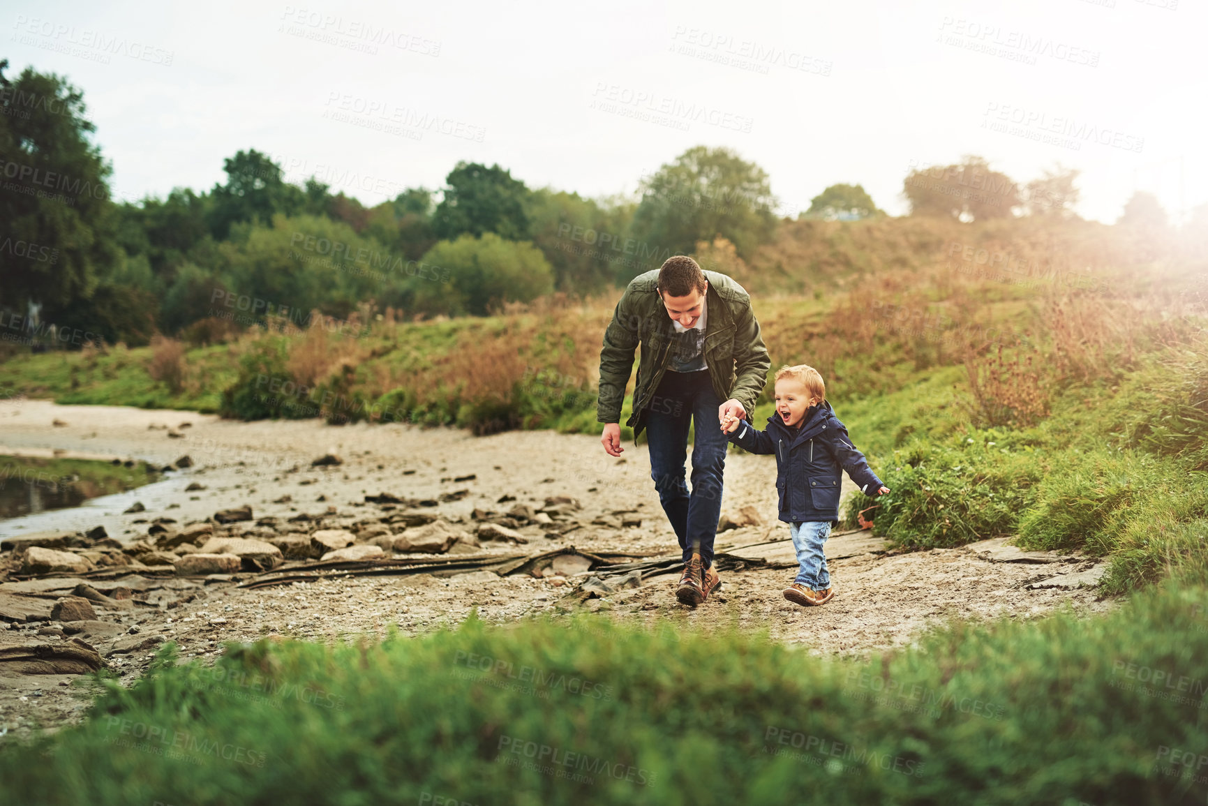 Buy stock photo Shot of a father out for a walk with his little son