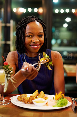 Buy stock photo Portrait of an attractive young woman eating a meal in a restaurant
