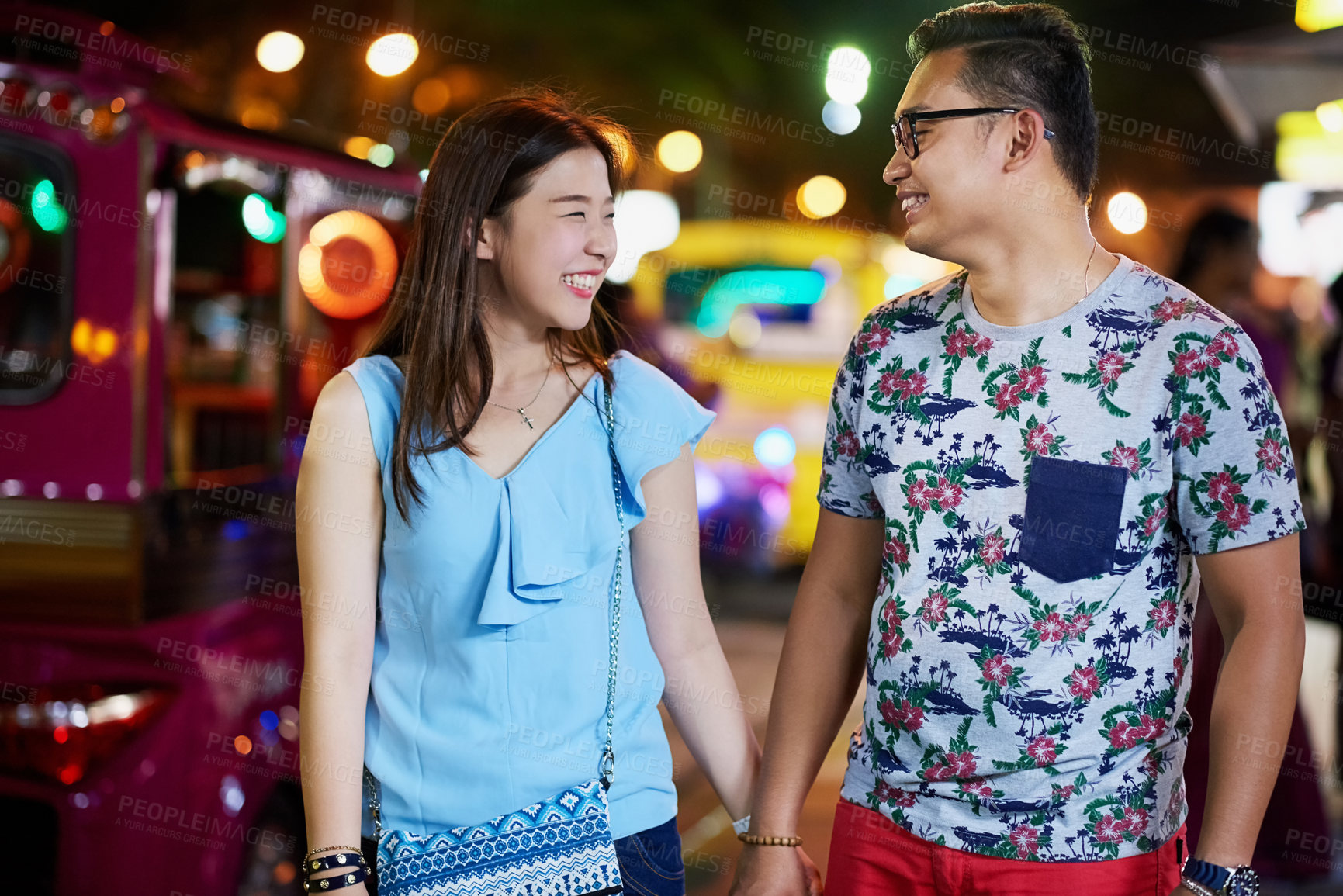 Buy stock photo Shot of a happy young couple spending the night out in the city