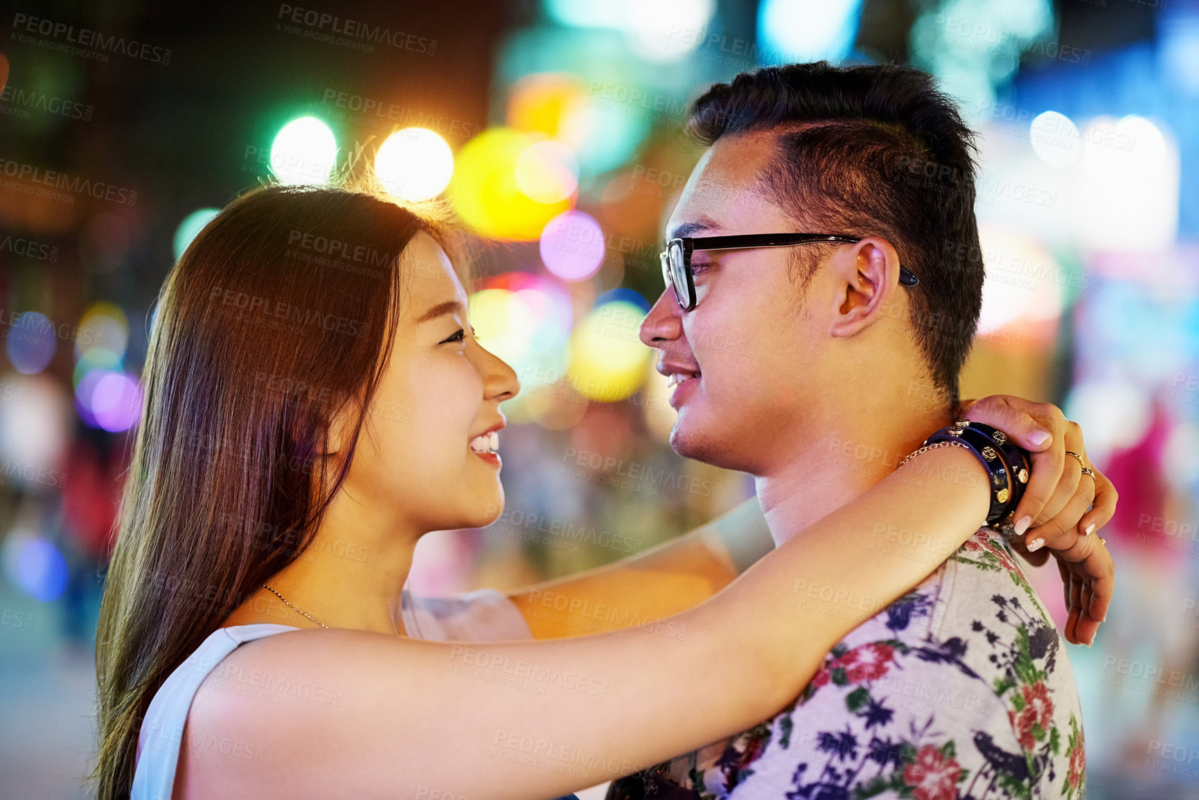 Buy stock photo Asian couple, smile and city travel with love or urban vacation with bokeh lights, anniversary or holiday. Man, woman and embrace in downtown Thailand for outdoor date or honeymoon, street or night