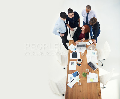 Buy stock photo Shot of group of businesspeople using a laptop together during a meeting in an office