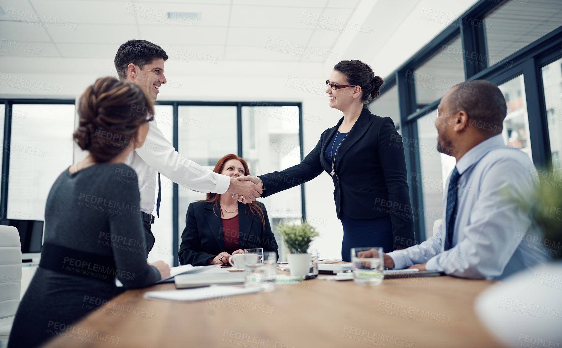 Buy stock photo Business people, handshake and welcome for deal with agreement, success and diversity in office. Women, men and teamwork as thank you for onboarding, partnership or negotiation in meeting for company