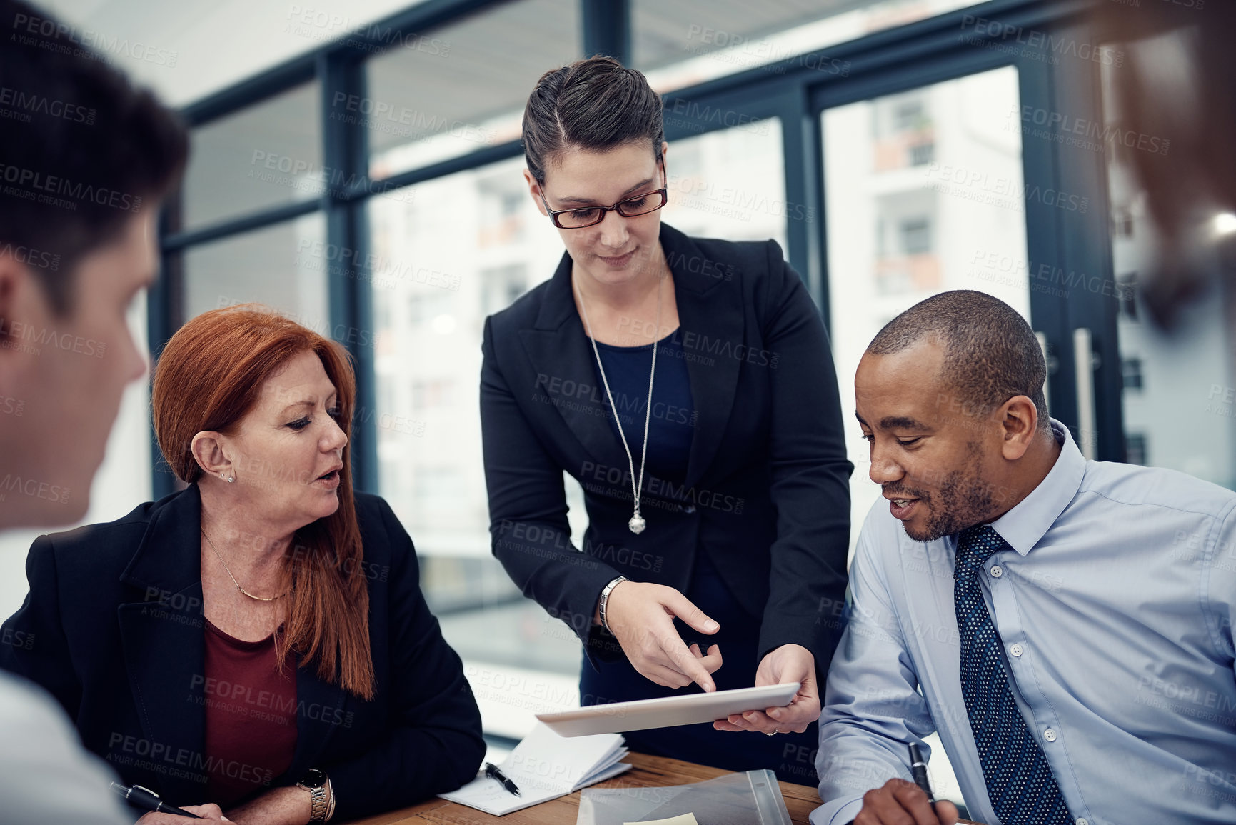 Buy stock photo Woman, tablet and group in office, meeting or discussion for brainstorming, solution or problem solving. Business people, listening and digital touchscreen in boardroom with app at insurance agency