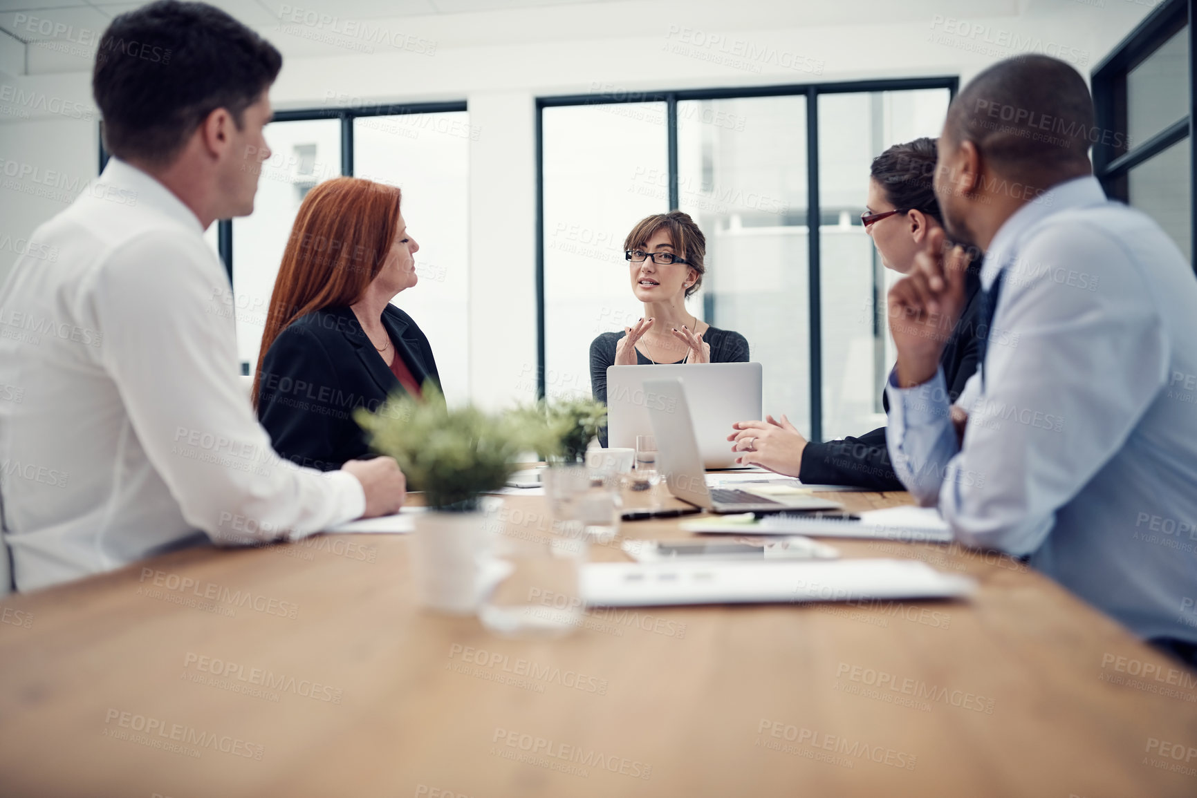 Buy stock photo Cropped shot of group of businesspeople having a meeting in an office