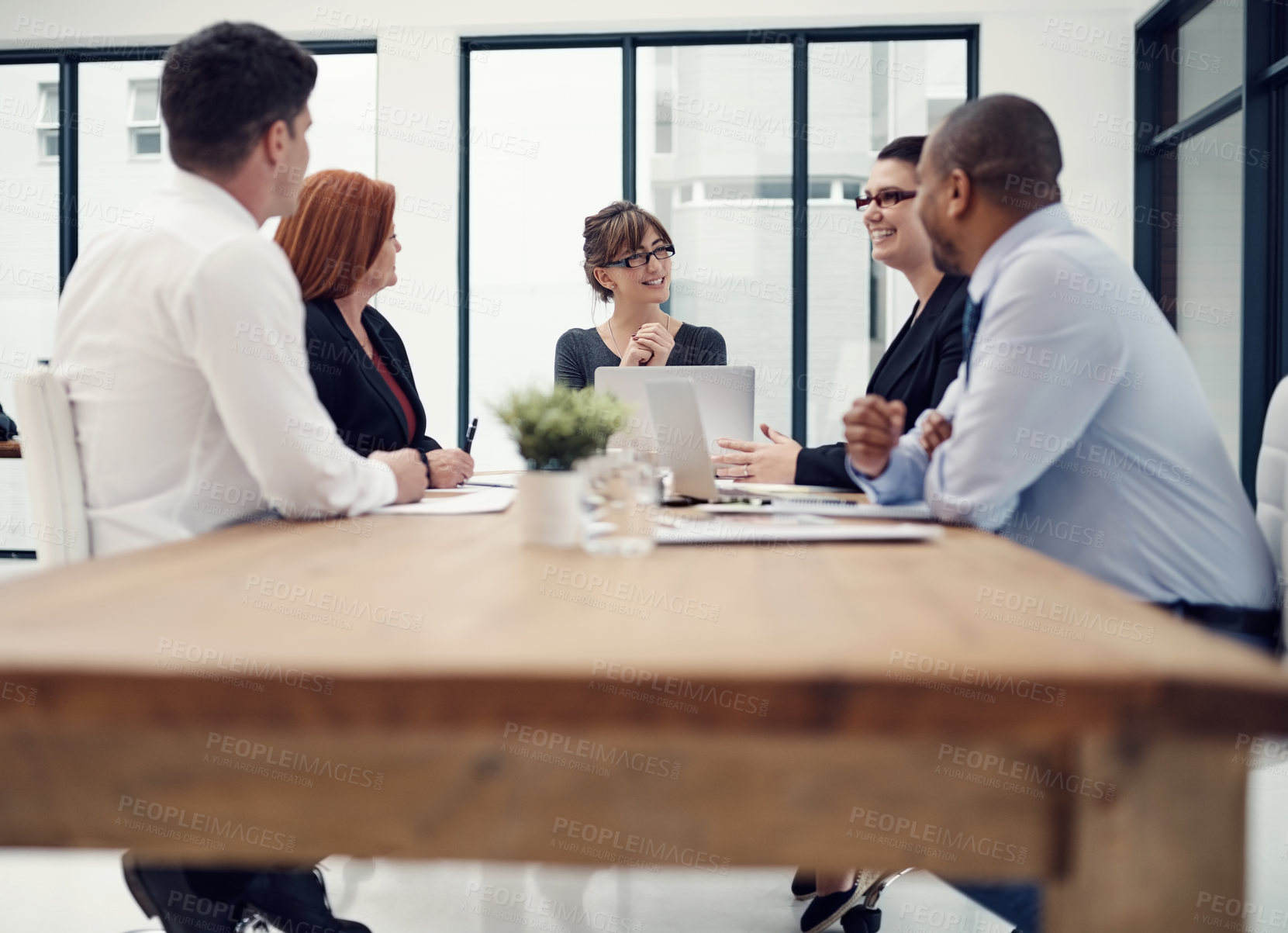 Buy stock photo Discussion, laptop and teamwork with business people in meeting for partnership, project proposal and company revenue. Client feedback, planning and mentor with employees in office for research