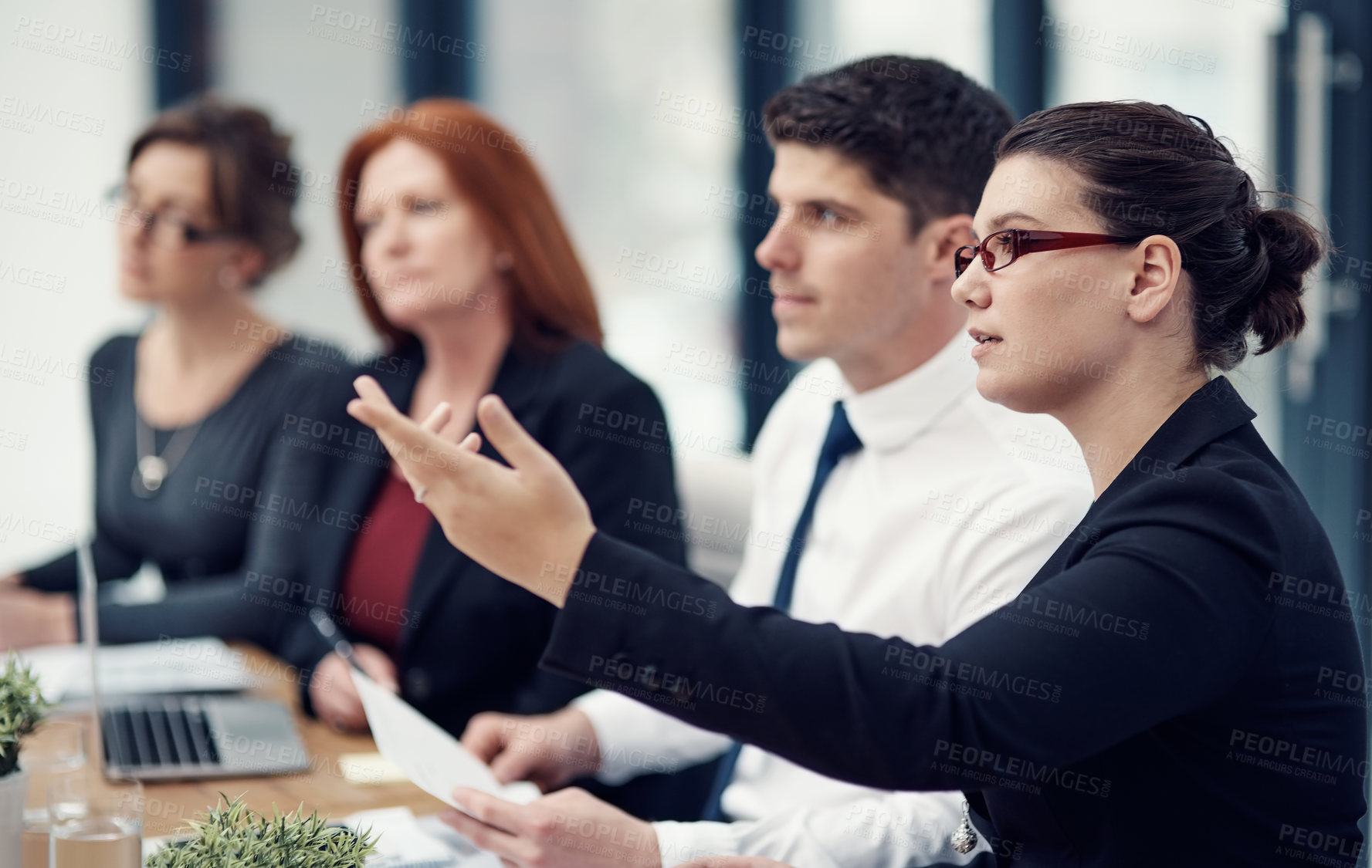 Buy stock photo Cropped shot of a panel of businesspeople giving feedback during a presentation in an office