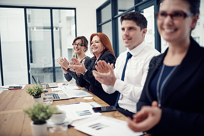 Buy stock photo Cropped shot of a group of businesspeople applauding while sitting in a boardroom