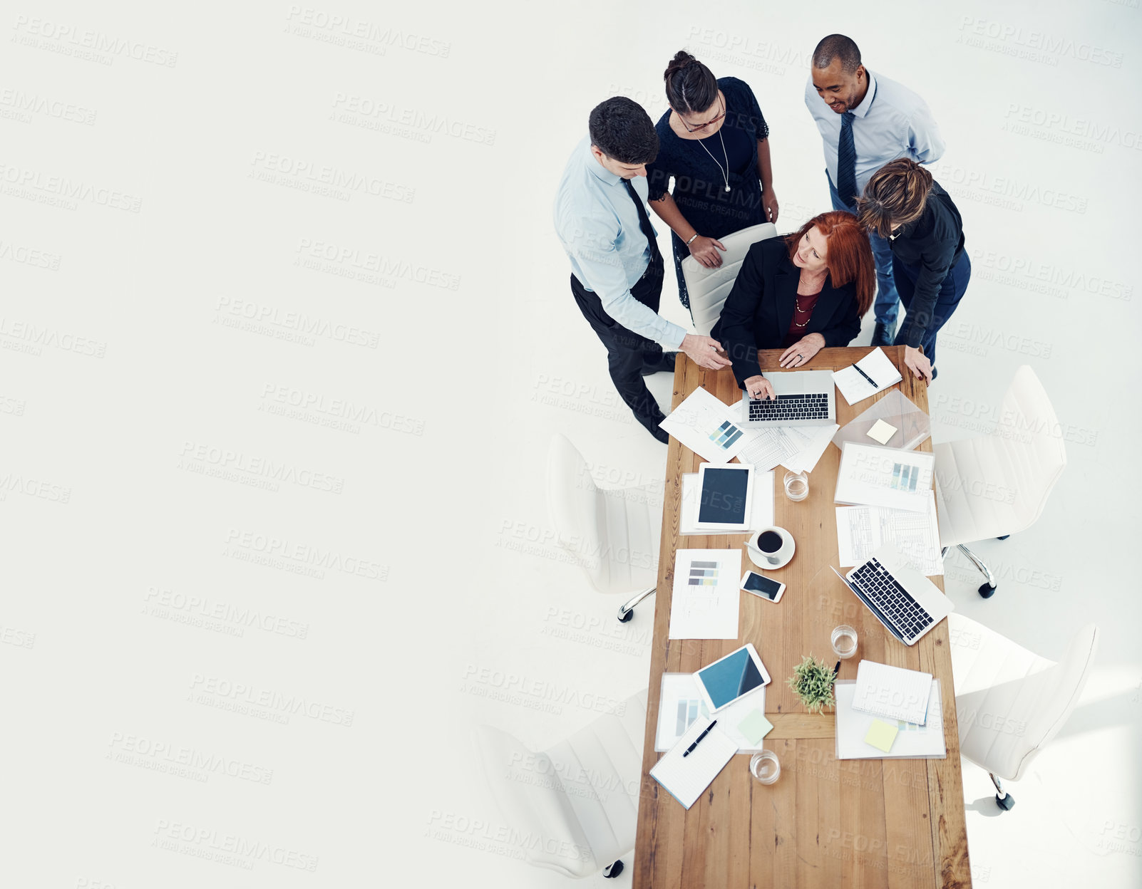 Buy stock photo Shot of group of businesspeople using a laptop together during a meeting in an office