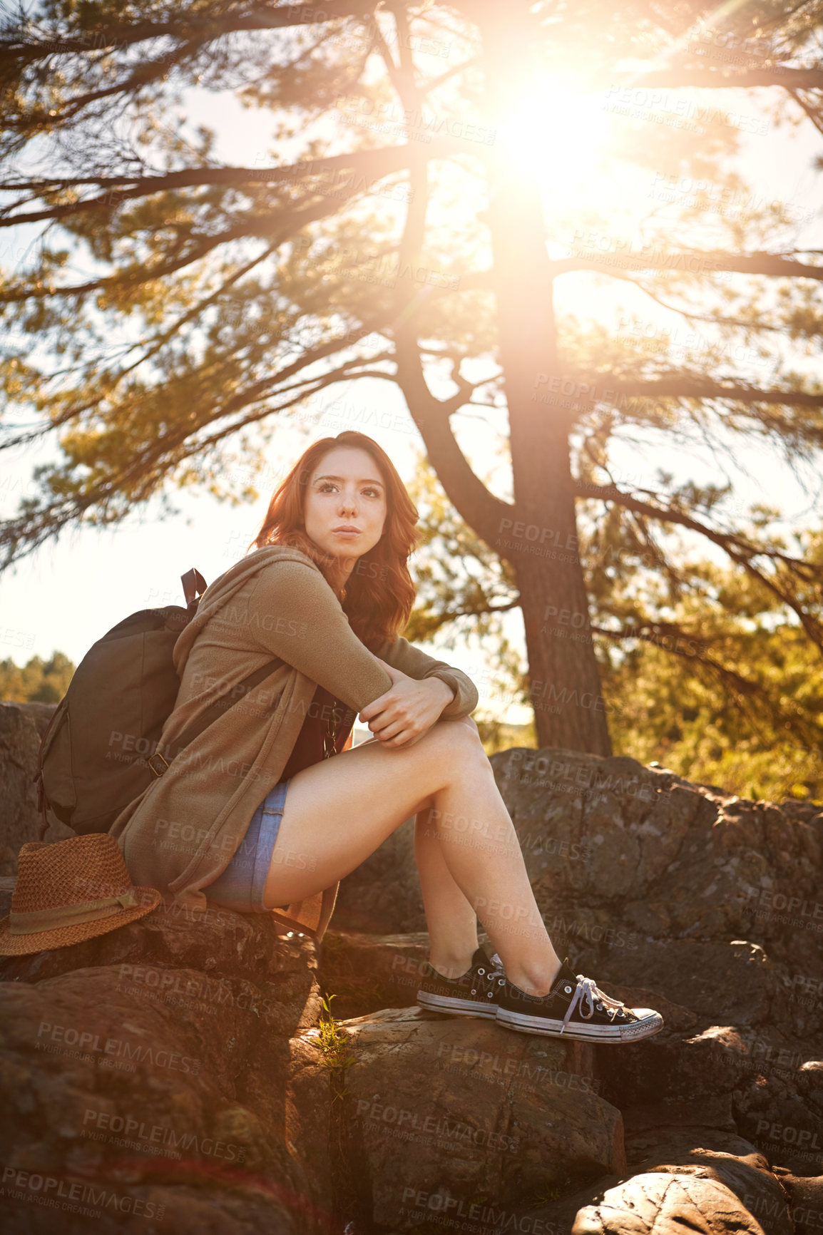 Buy stock photo Shot of an attractive young woman hiking while on an overseas trip