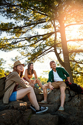 Buy stock photo Shot of three young people hiking while on an overseas trip