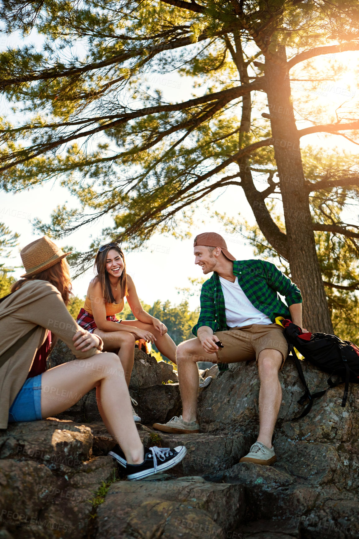 Buy stock photo Shot of three young people hiking while on an overseas trip