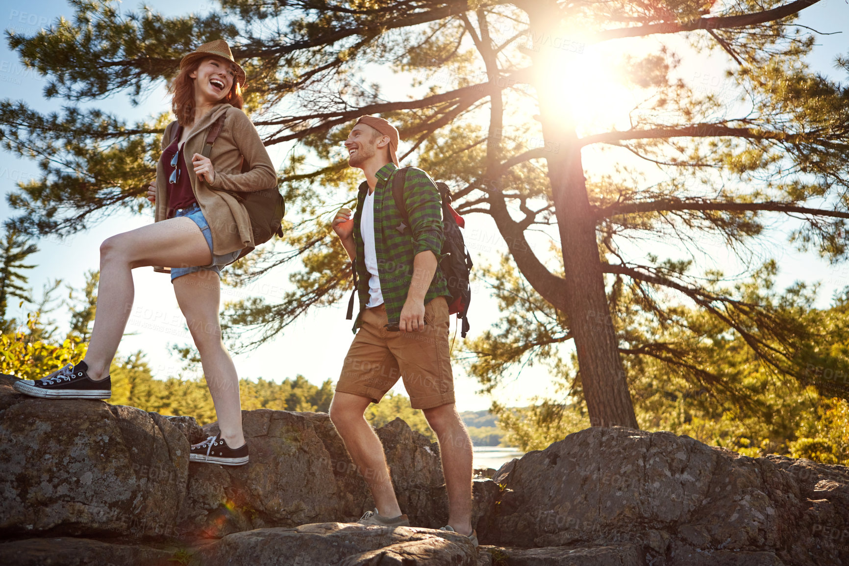 Buy stock photo Nature, hiking and couple walking with trees, blue sky and adventure holiday in forest. Trekking, man and woman on sustainable travel vacation together in park with rocks, climbing and outdoor date.