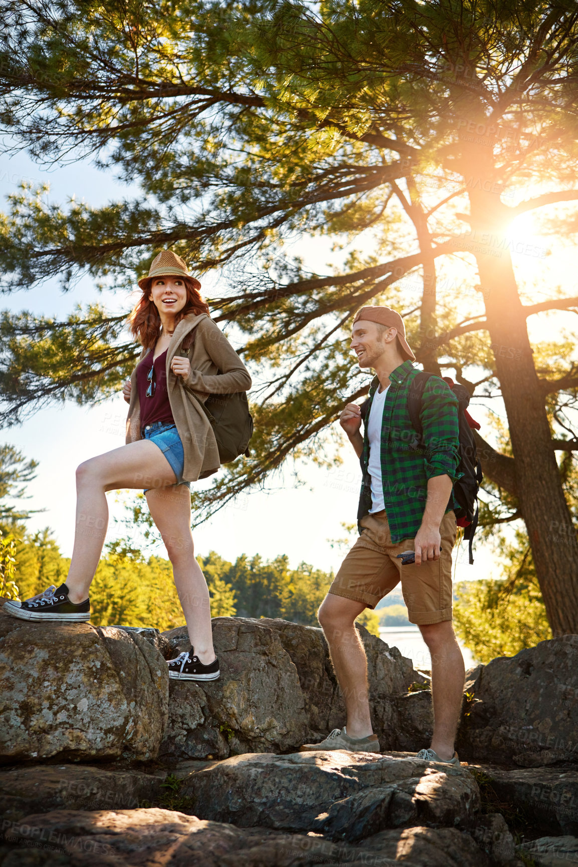 Buy stock photo Forest, hiking and couple walking with trees, nature and adventure holiday in outdoor park. Trekking, man and woman on sustainable travel vacation together in woods with smile, rocks and happy date