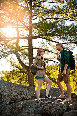 Buy stock photo Nature, hiking and couple walking with discussion, trees and adventure holiday in mountain. Trekking, man and woman on sustainable travel vacation together in park with chat, rocks and outdoor date