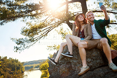 Buy stock photo Shot of an affectionate young couple hiking while on an overseas trip