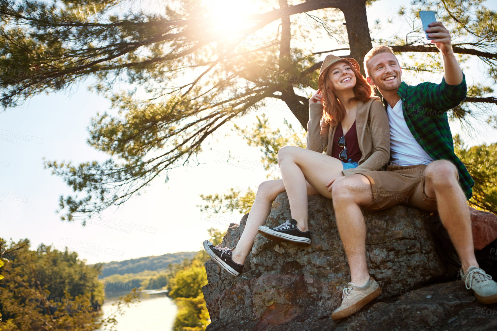 Buy stock photo Shot of an affectionate young couple hiking while on an overseas trip