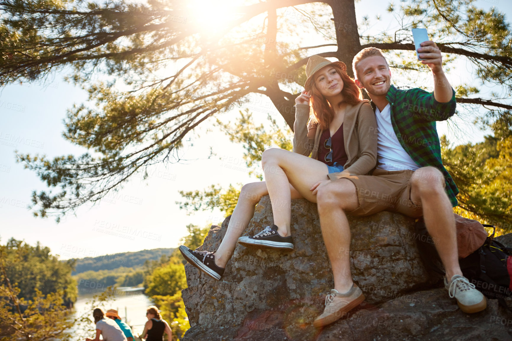 Buy stock photo Shot of an affectionate young couple hiking while on an overseas trip