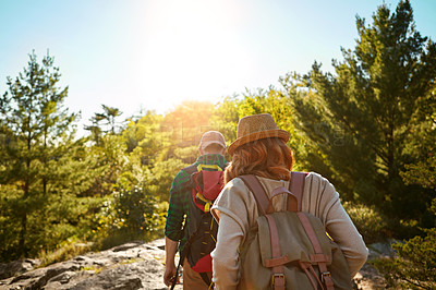 Buy stock photo Nature, hiking and couple with trees, walking and adventure holiday in mountain from back. Trekking, man and woman on travel vacation together in park with sunshine, bush and outdoor climbing date 
