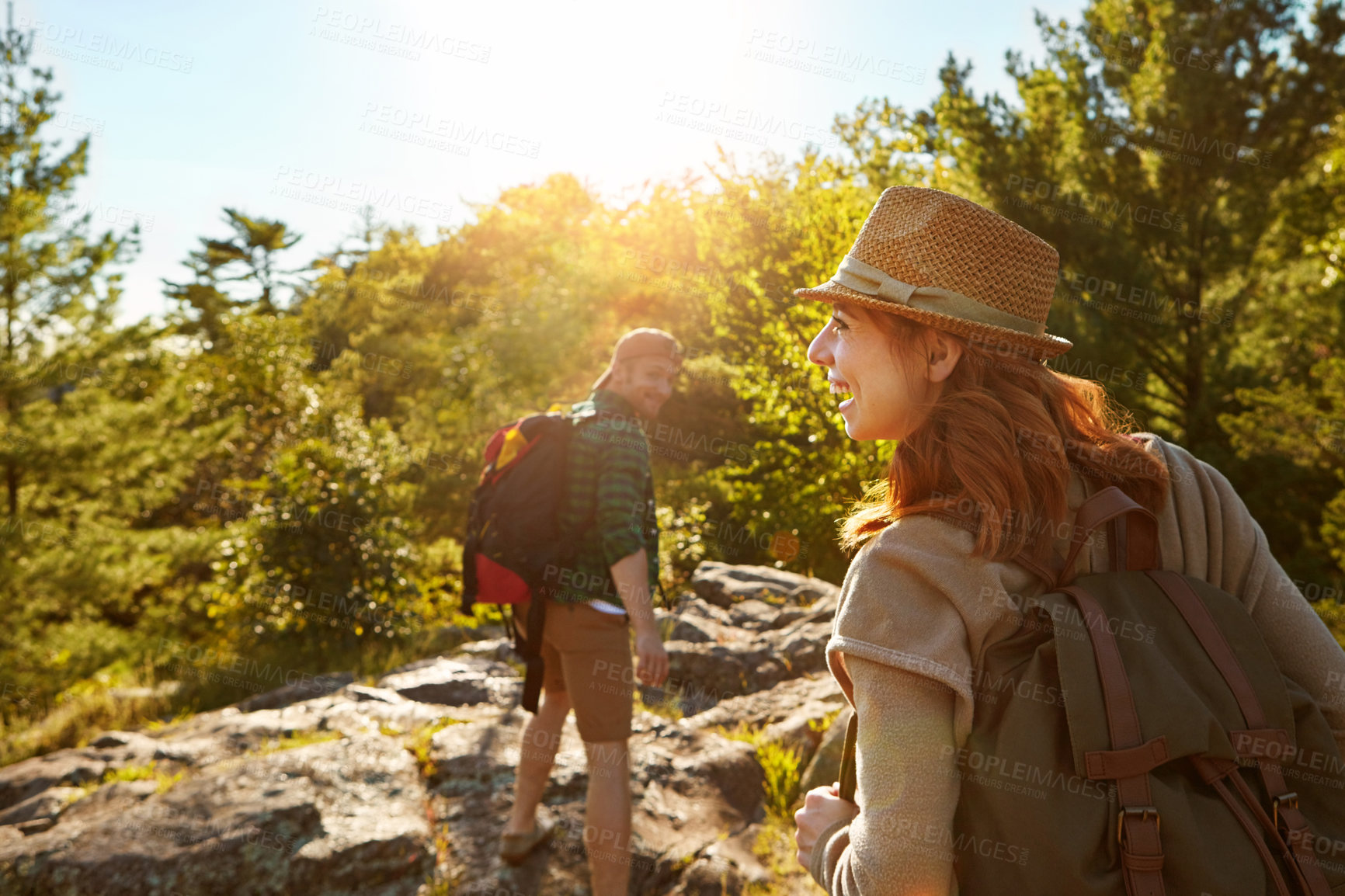 Buy stock photo Nature, hiking and couple with sunshine, climbing and adventure holiday in mountain from back. Trekking, man and woman on travel vacation together in park with trees, bush and outdoor walking date 