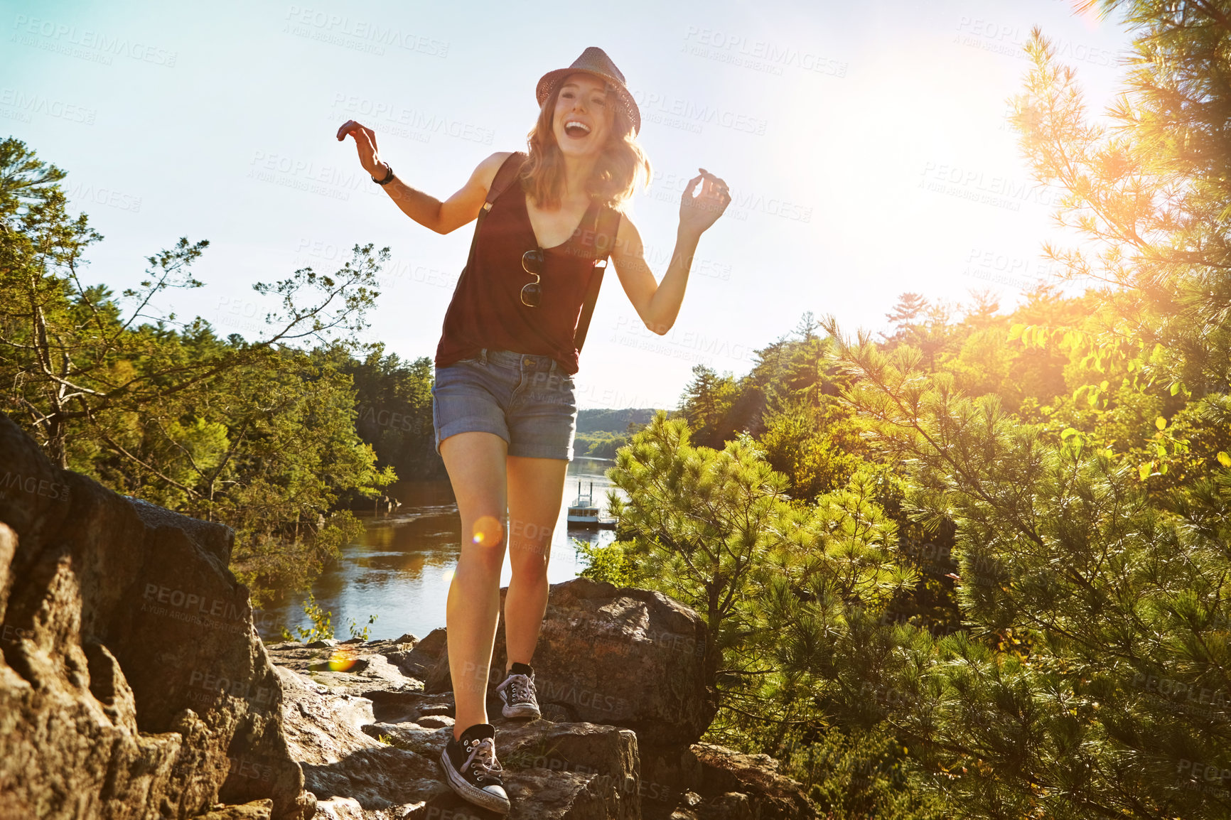 Buy stock photo Hiking, laughing and woman in nature with lake for adventure, trekking and freedom outdoors. Morning, mountain and happy person for travel, walking and exercise on holiday, journey and vacation