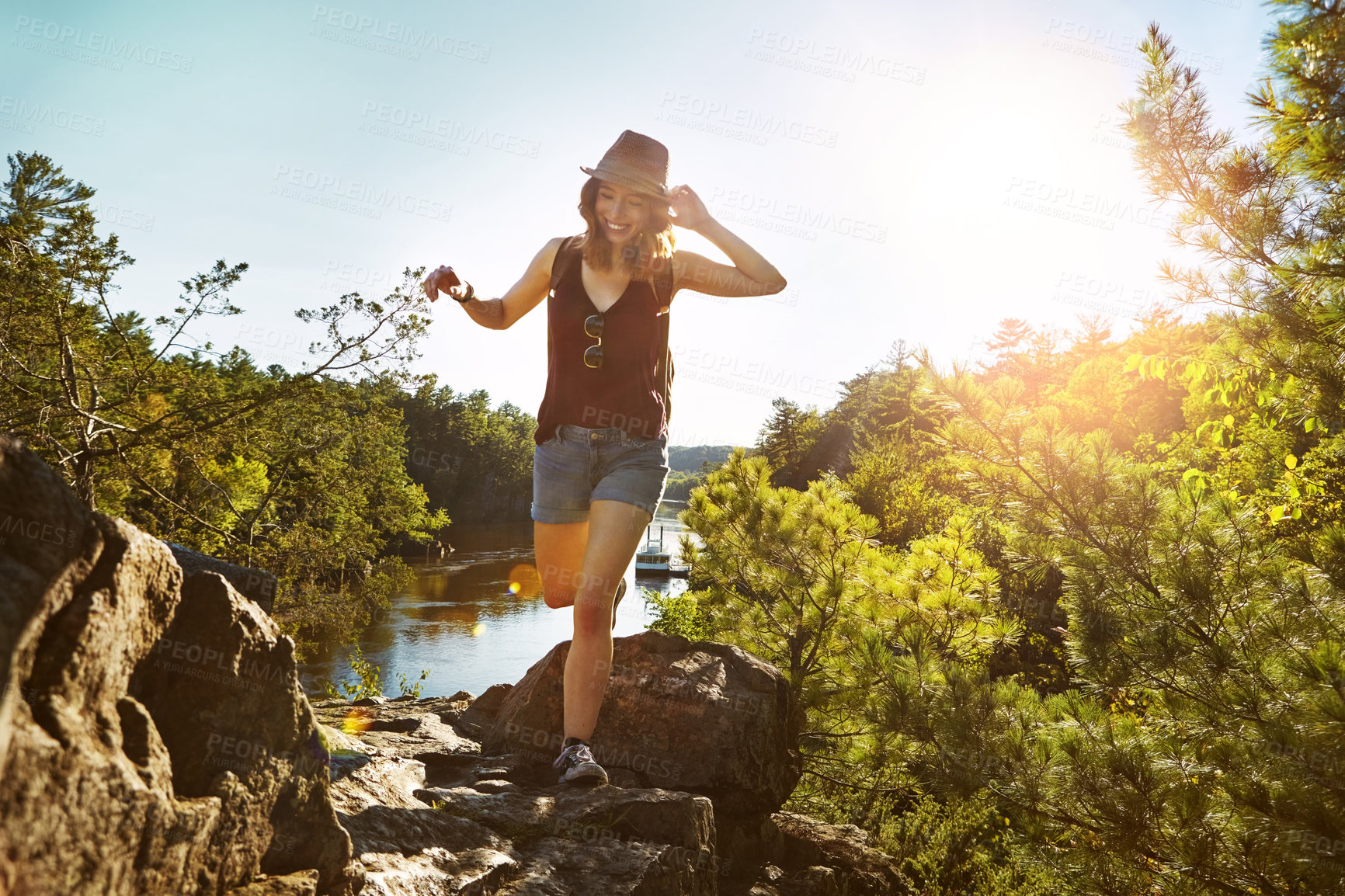 Buy stock photo Hiking, sunshine and woman on mountain with lake for adventure, trekking and freedom. Travel, nature and happy person outdoors for wellness, walking and exercise on holiday, journey and vacation