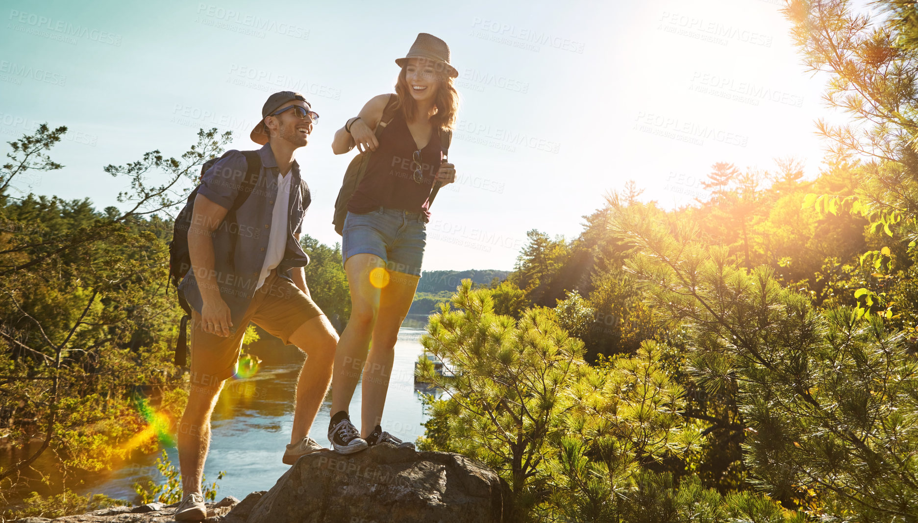 Buy stock photo Nature, hiking and couple walking on rocks at river on adventure holiday in mountain with trees, cliff, or water. Trekking, man and woman on travel vacation together at lake, park or outdoor climbing